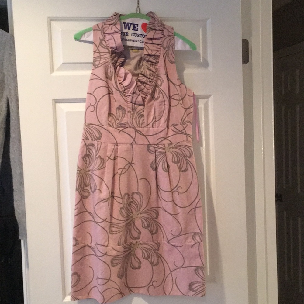 Pink ruffled neck dress.